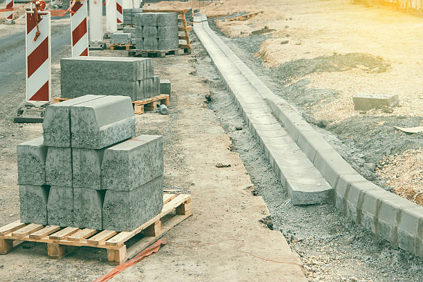 Sidewalk under construction, curb and gutter WelldoneStar installation in progress. Shallow dof and vintage style.
